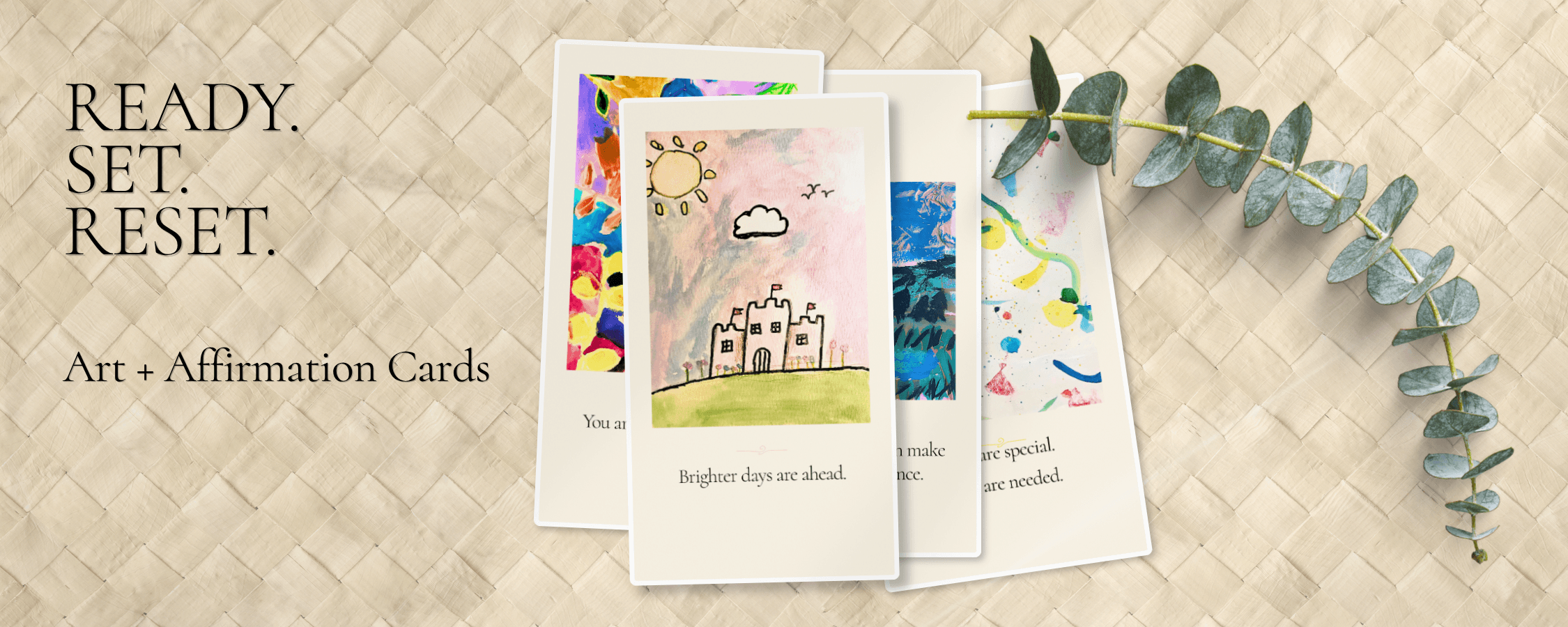 Ready. Set. Reset. — Art + Affirmation Cards. Four cards from the deck fanned out, including a watercolor castle reading 'Brighter days are ahead.', beside a sprig of eucalyptus.